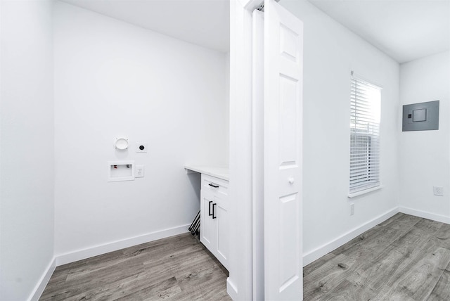 clothes washing area featuring hookup for a washing machine, electric panel, electric dryer hookup, and light hardwood / wood-style floors