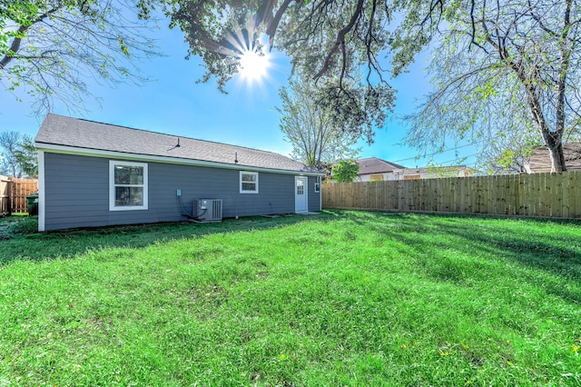 back of house featuring cooling unit and a yard