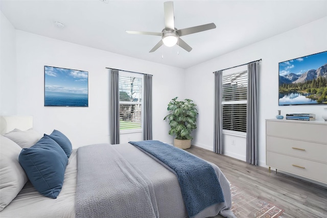 bedroom with ceiling fan and light hardwood / wood-style floors