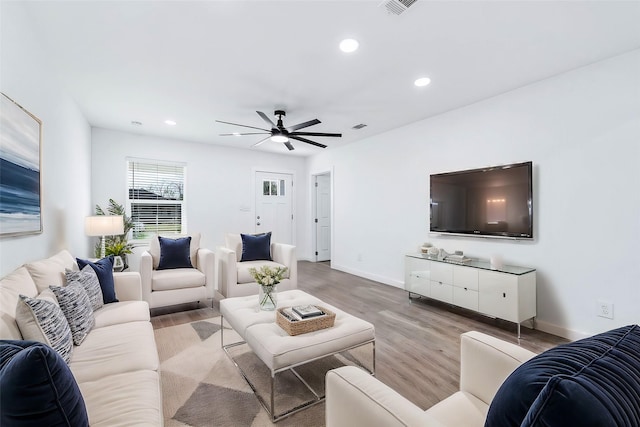 living room with ceiling fan and light wood-type flooring