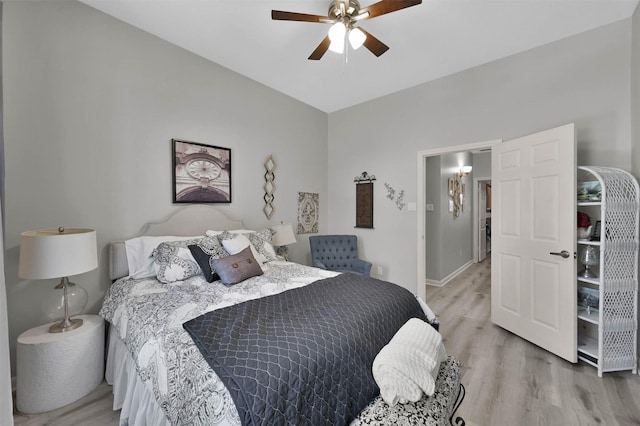 bedroom with light hardwood / wood-style flooring and ceiling fan