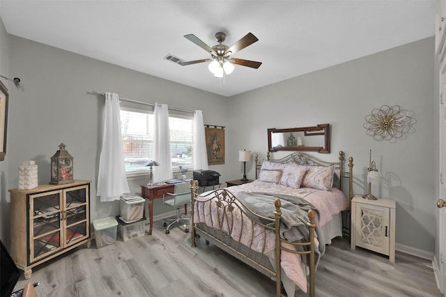 bedroom with light wood-type flooring and ceiling fan