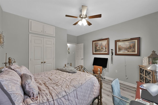 bedroom featuring light wood-type flooring, a closet, and ceiling fan