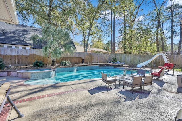 view of swimming pool with a patio area, an in ground hot tub, and a water slide