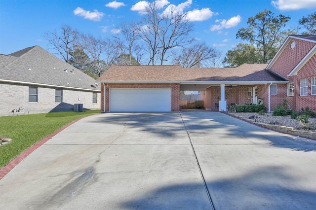 view of front of property with cooling unit, a front yard, and a garage