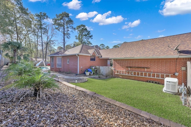 rear view of property featuring a lawn