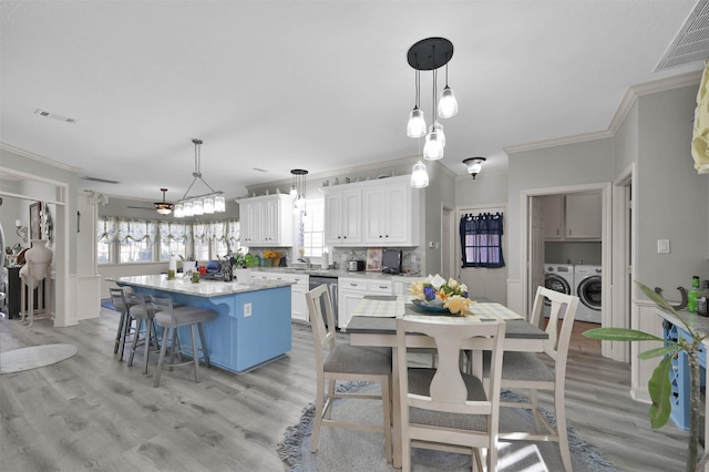 kitchen with a center island, white cabinetry, hanging light fixtures, and ceiling fan