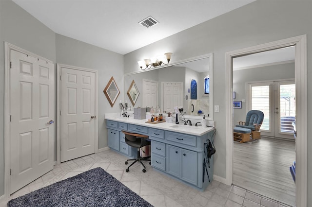 bathroom with french doors and vanity