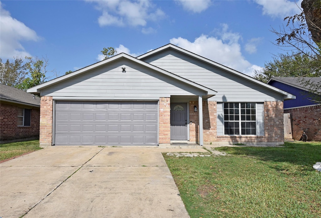 ranch-style home with a garage and a front lawn