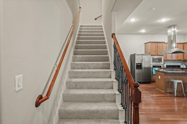 stairway featuring hardwood / wood-style flooring