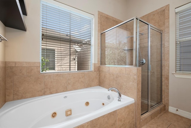 bathroom featuring tile patterned flooring and shower with separate bathtub