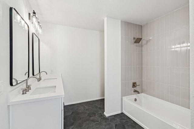 bathroom featuring vanity and tiled shower / bath