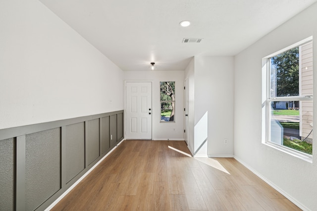 entrance foyer with light hardwood / wood-style floors and a wealth of natural light