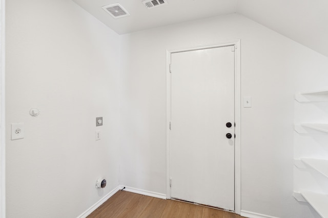 clothes washing area with hardwood / wood-style flooring and electric dryer hookup