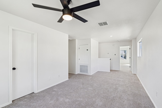 interior space featuring ceiling fan and light colored carpet