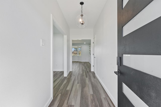 corridor with hardwood / wood-style floors