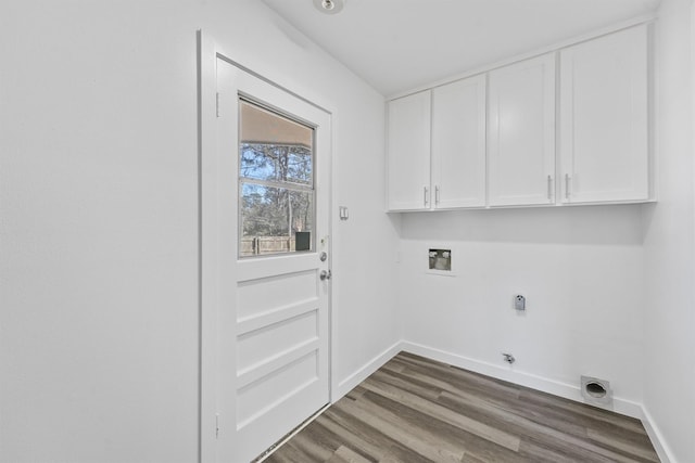 laundry room with dark wood-type flooring, electric dryer hookup, hookup for a washing machine, cabinets, and hookup for a gas dryer