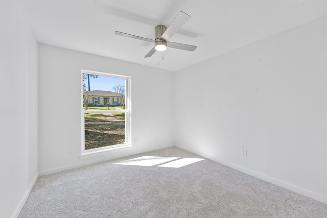 unfurnished room featuring ceiling fan and carpet