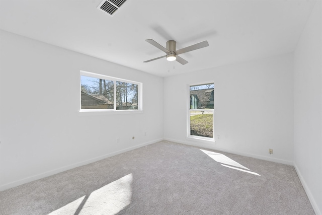 carpeted spare room with ceiling fan