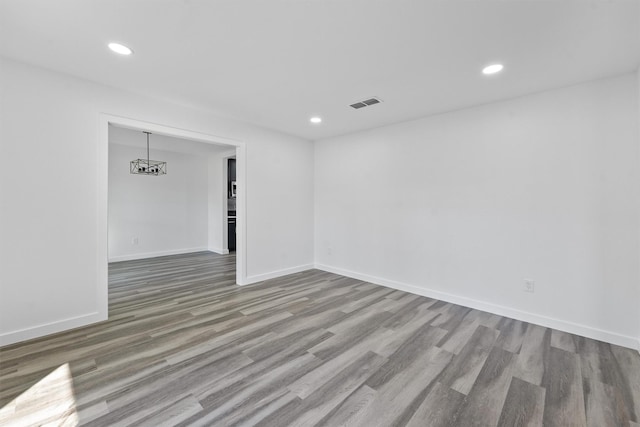 spare room featuring wood-type flooring