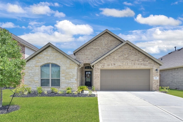 view of front of house with a garage and a front lawn