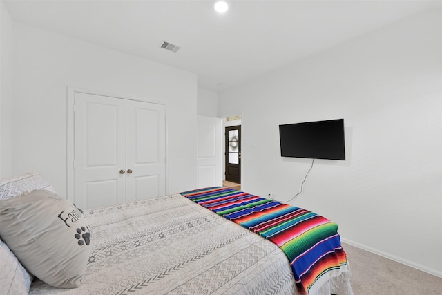 carpeted bedroom with a closet