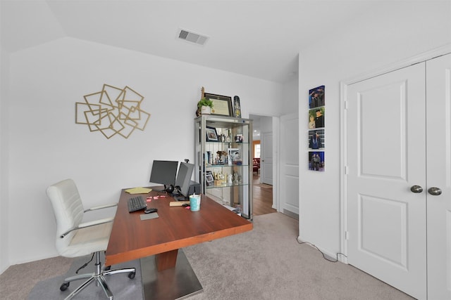 office space with light colored carpet and lofted ceiling