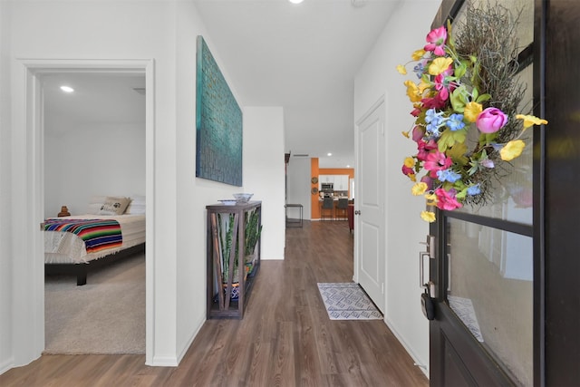 corridor with hardwood / wood-style flooring