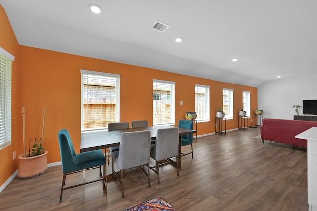 dining area featuring dark wood-type flooring and lofted ceiling