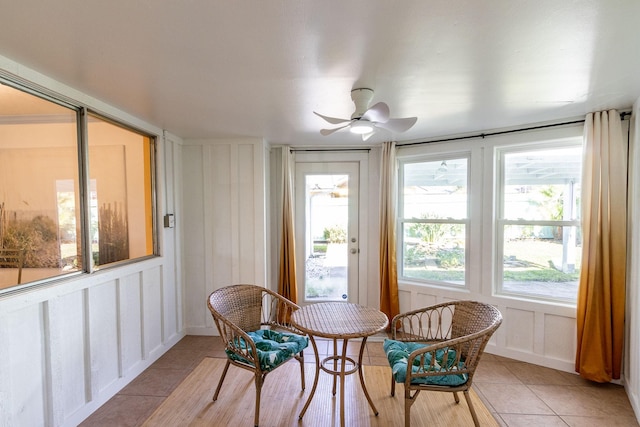 sunroom featuring ceiling fan