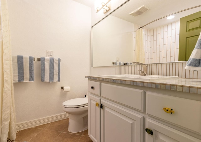 bathroom with tile patterned floors, vanity, curtained shower, and toilet