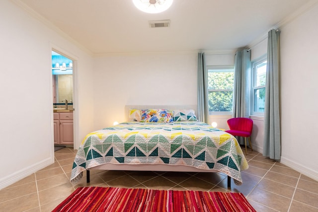 tiled bedroom with connected bathroom, crown molding, and sink