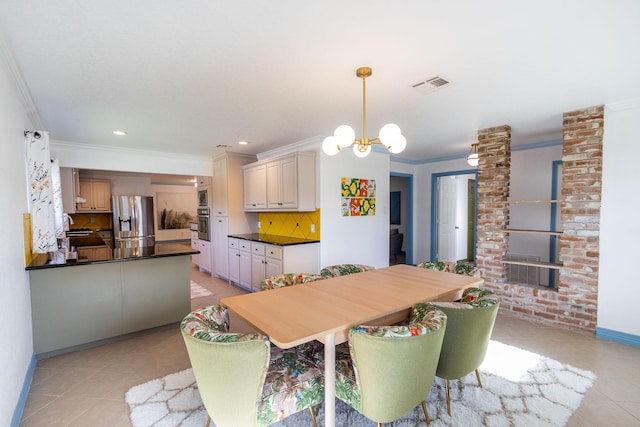 tiled dining room featuring crown molding, sink, and a notable chandelier