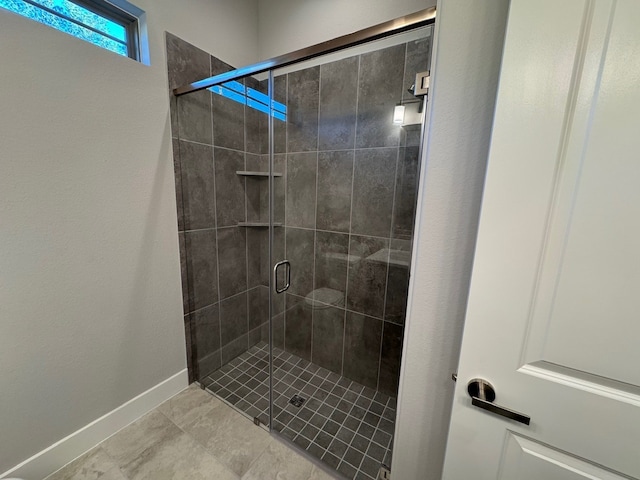 bathroom featuring tile patterned flooring and walk in shower