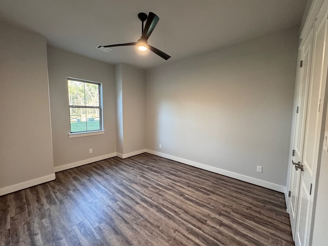 unfurnished room with ceiling fan and dark hardwood / wood-style floors