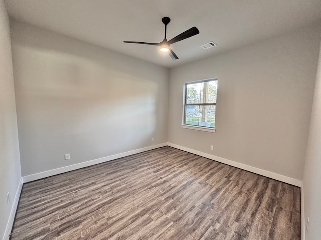 spare room with ceiling fan and wood-type flooring