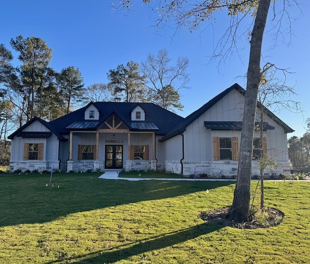 view of front of house featuring a front yard and french doors