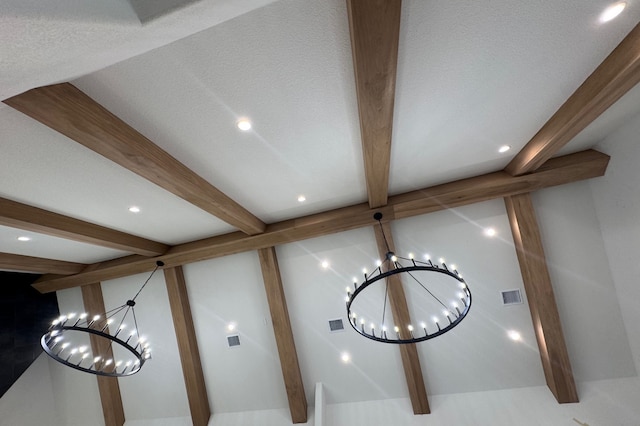 details with beamed ceiling and an inviting chandelier