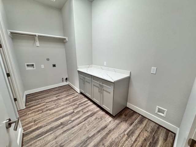 washroom with cabinets, hookup for a washing machine, electric dryer hookup, and hardwood / wood-style floors