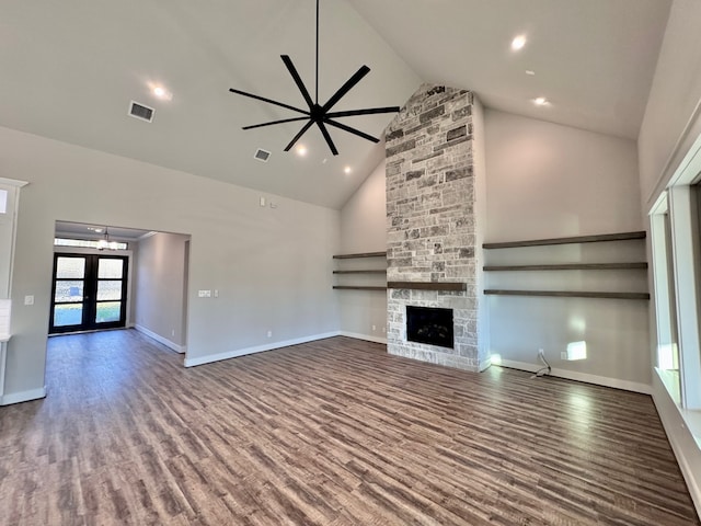 unfurnished living room featuring french doors, ceiling fan, wood-type flooring, high vaulted ceiling, and a fireplace