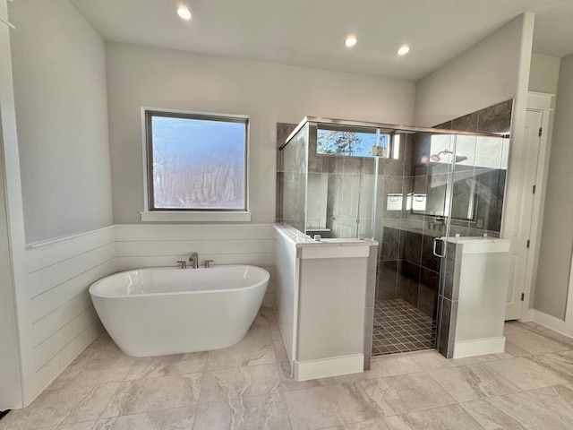 bathroom featuring a wealth of natural light and plus walk in shower