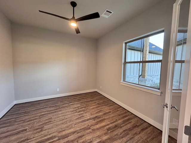 empty room featuring ceiling fan and dark hardwood / wood-style floors