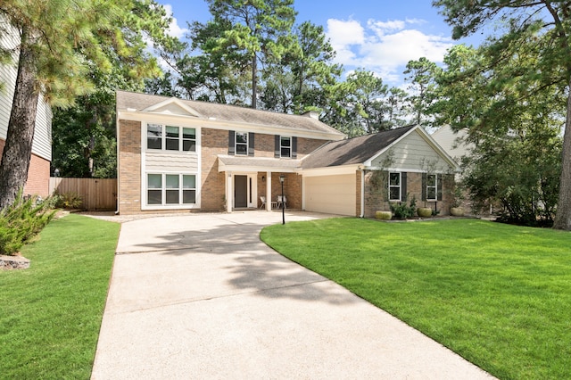 view of front of house with a front yard and a garage