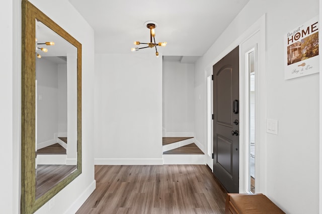 hallway with a chandelier and wood-type flooring