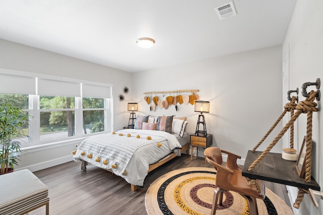 bedroom with wood-type flooring