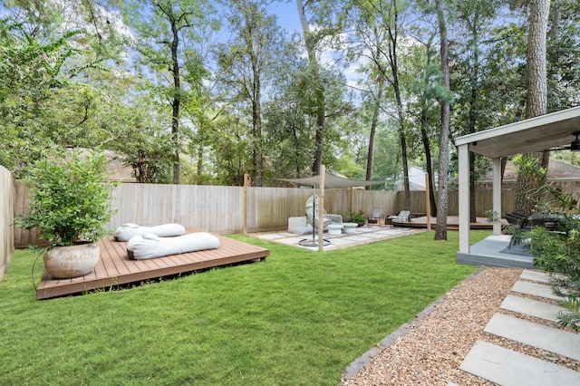 view of yard with a patio area and a wooden deck