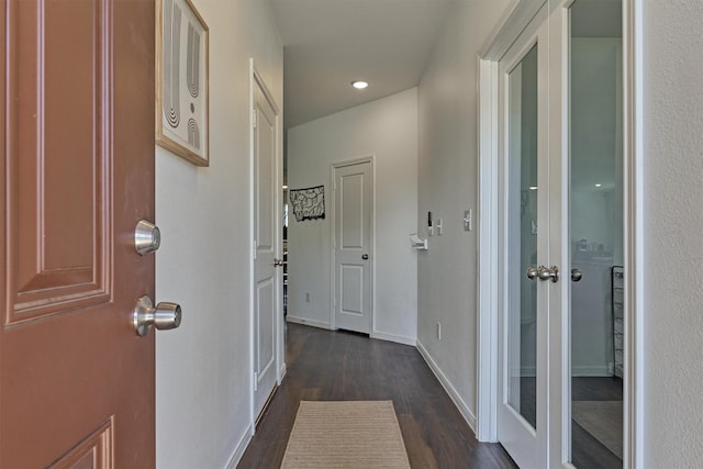 corridor featuring dark hardwood / wood-style floors and french doors