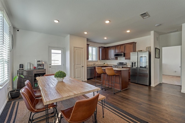 dining area with dark hardwood / wood-style flooring and a wealth of natural light