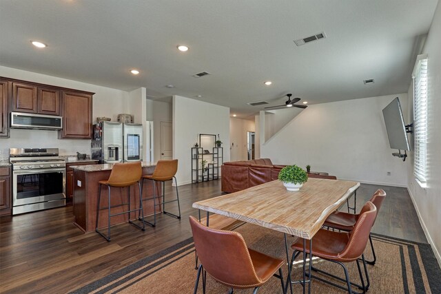 dining area featuring ceiling fan and dark hardwood / wood-style flooring