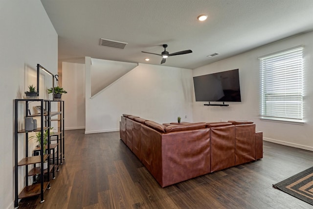 living room with ceiling fan and dark hardwood / wood-style flooring